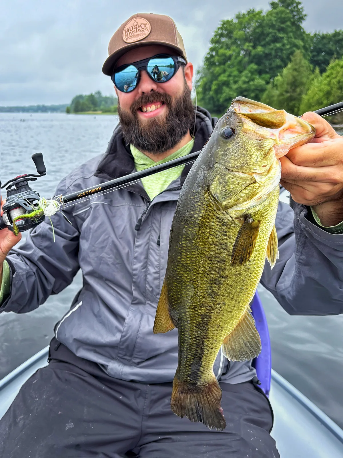 Andrew from Fishing Loons holding a largemouth bass while fishing.