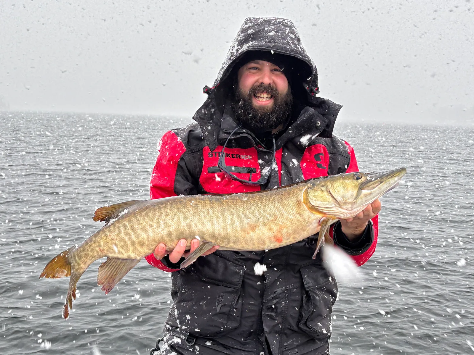 Andrew from Fishing Loons holding a muskie while fishing.