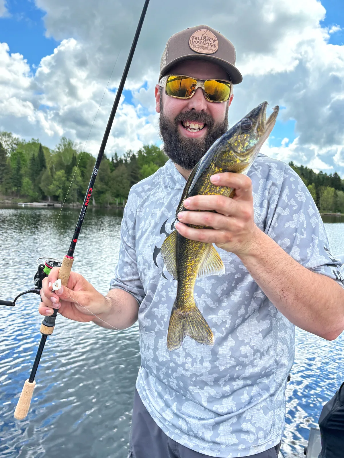 Andrew from Fishing Loons holding a walleye while fishing.