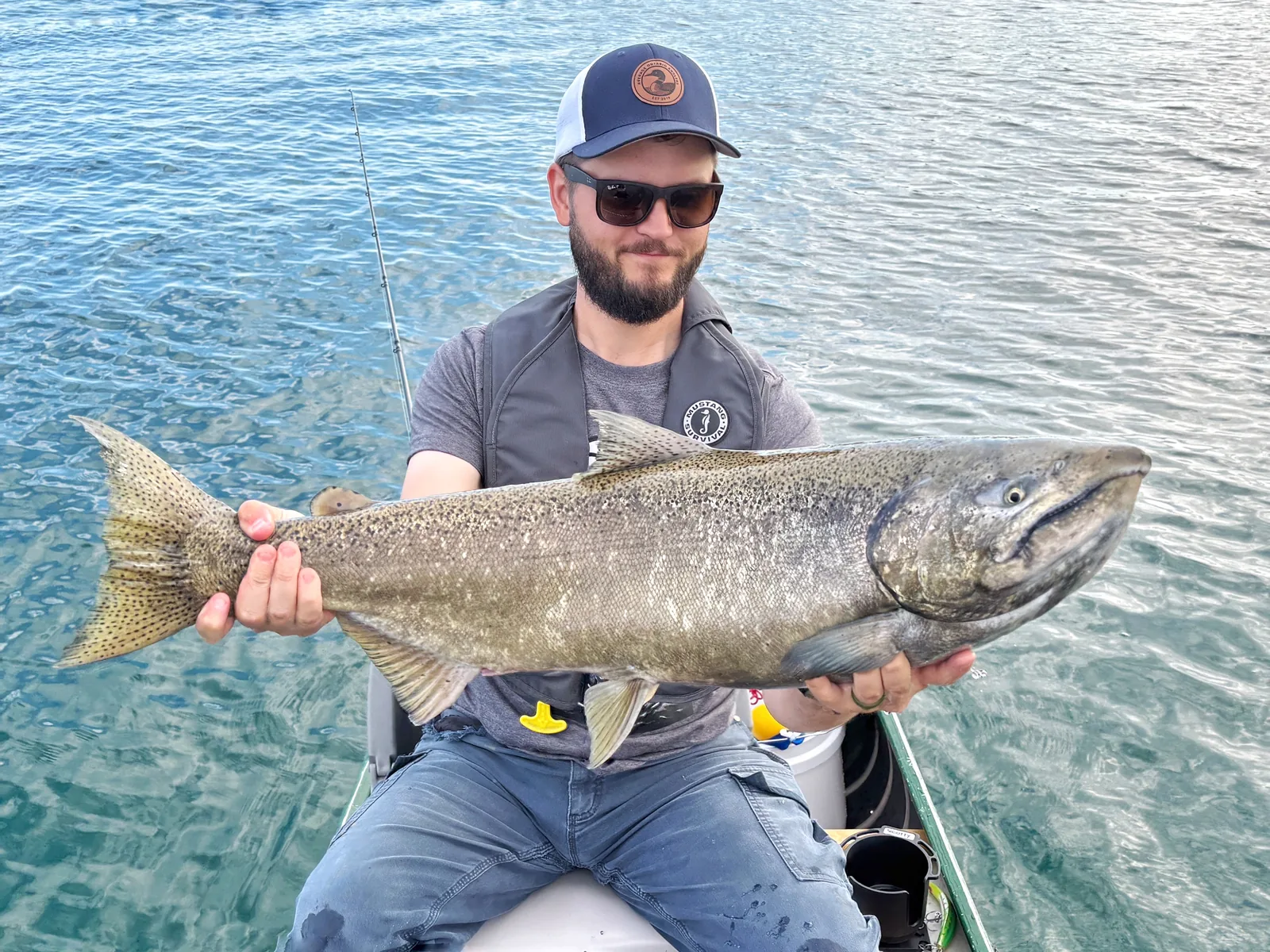 Jesse from Fishing Loons holding a chinook salmon while fishing.