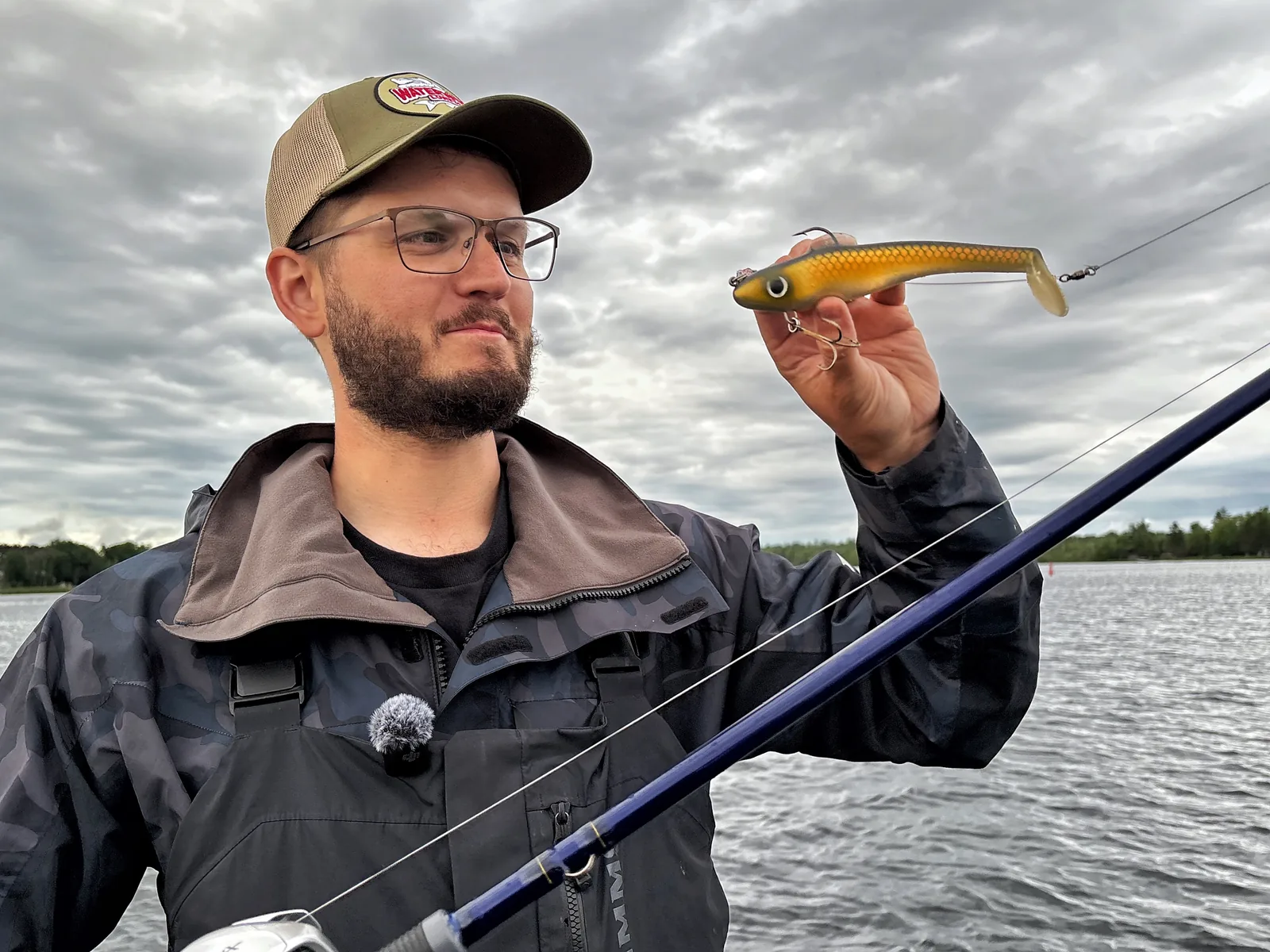 Jesse from Fishing Loons holding fishing gear on the water.