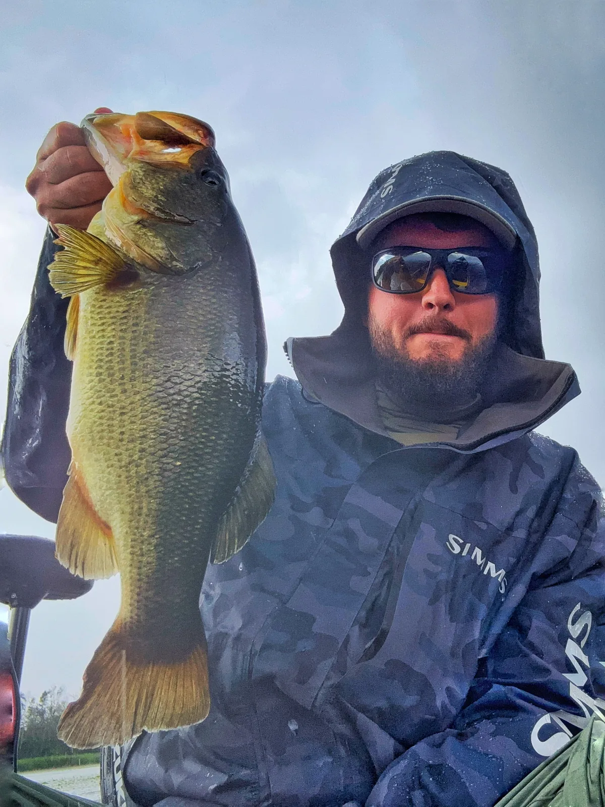 Jesse from Fishing Loons holding a largemouth bass while fishing.