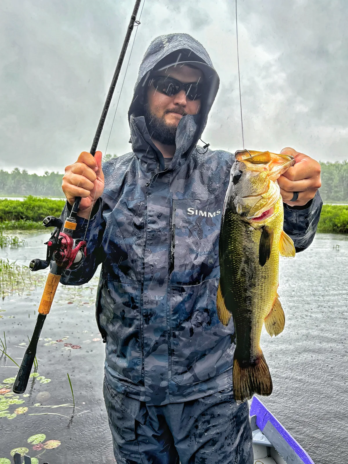 Jesse from Fishing Loons holding a largemouth bass while fishing.
