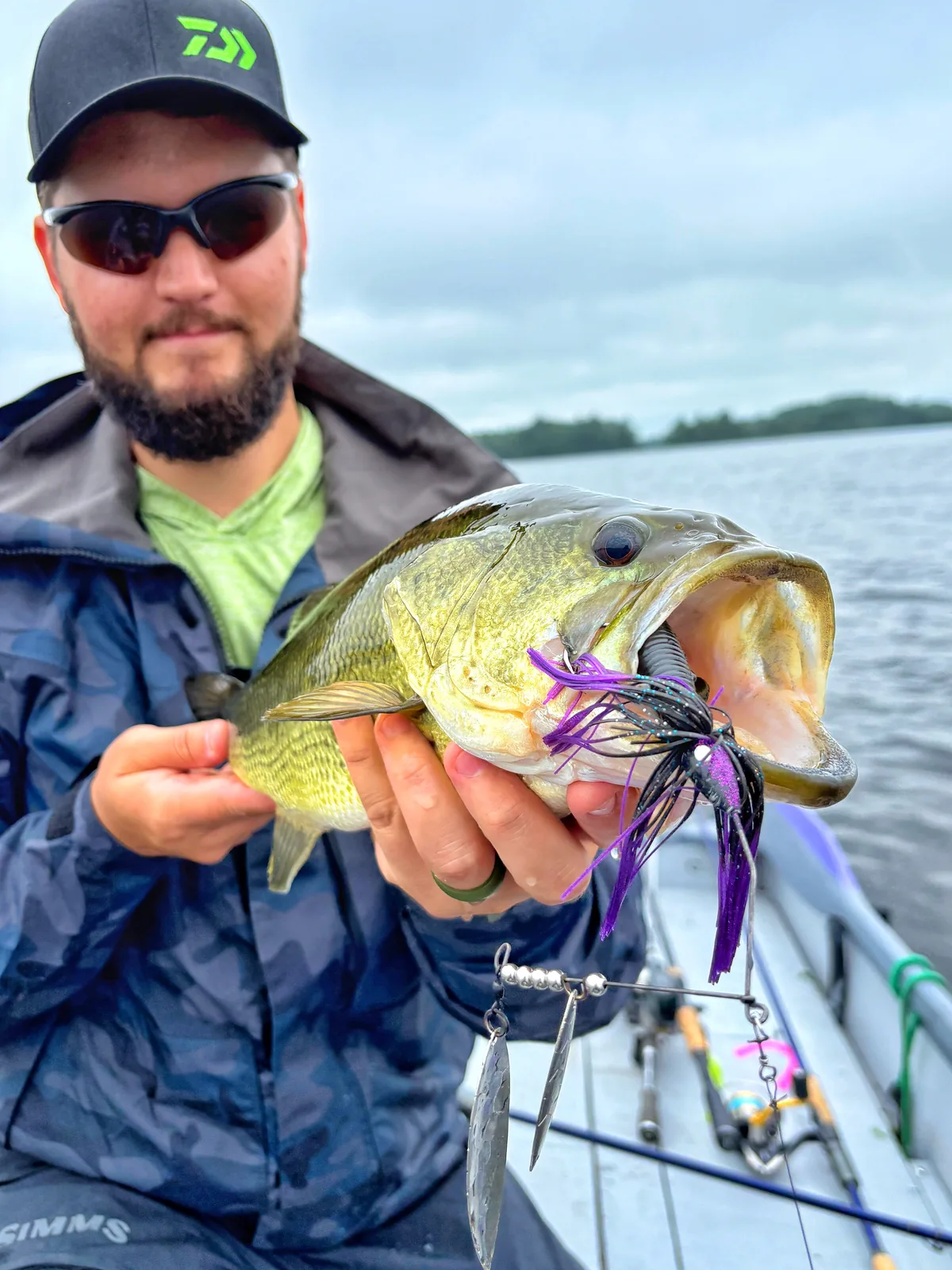 Jesse from Fishing Loons holding a largemouth bass while fishing.