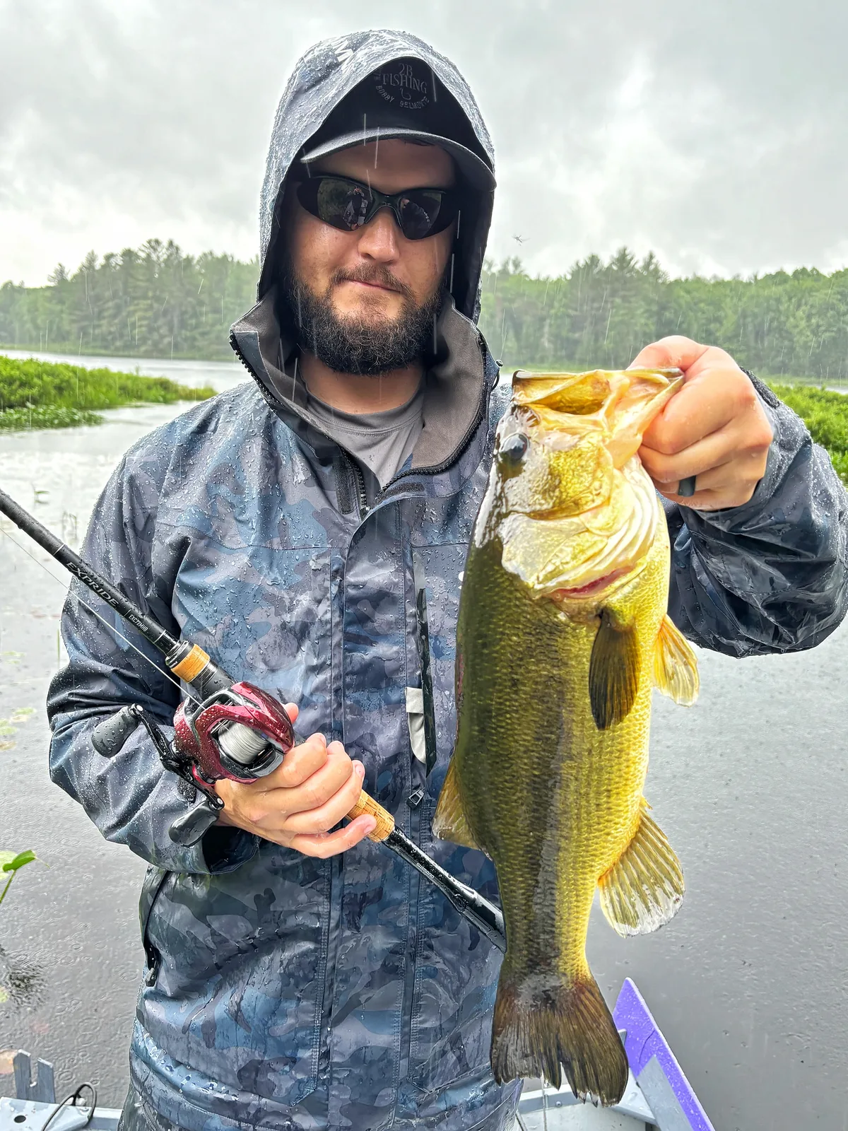 Jesse from Fishing Loons holding a largemouth bass while fishing.