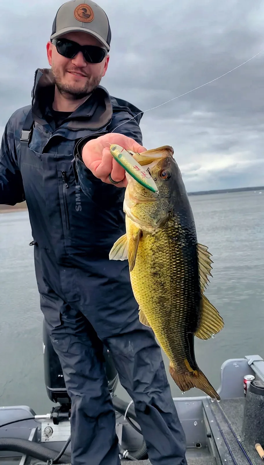 Jesse from Fishing Loons holding a largemouth bass while fishing.