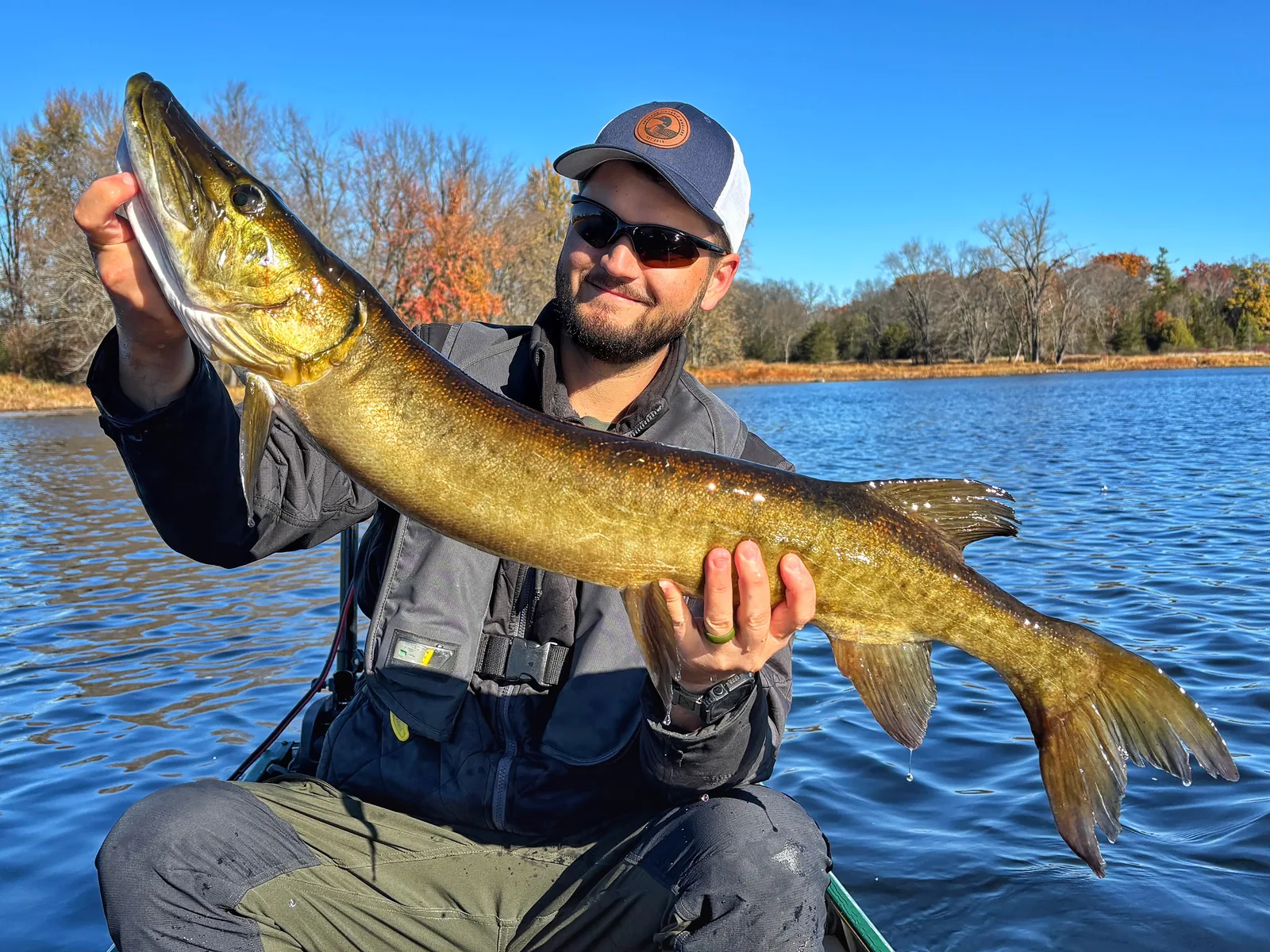 Jesse from Fishing Loons holding a muskie while fishing.