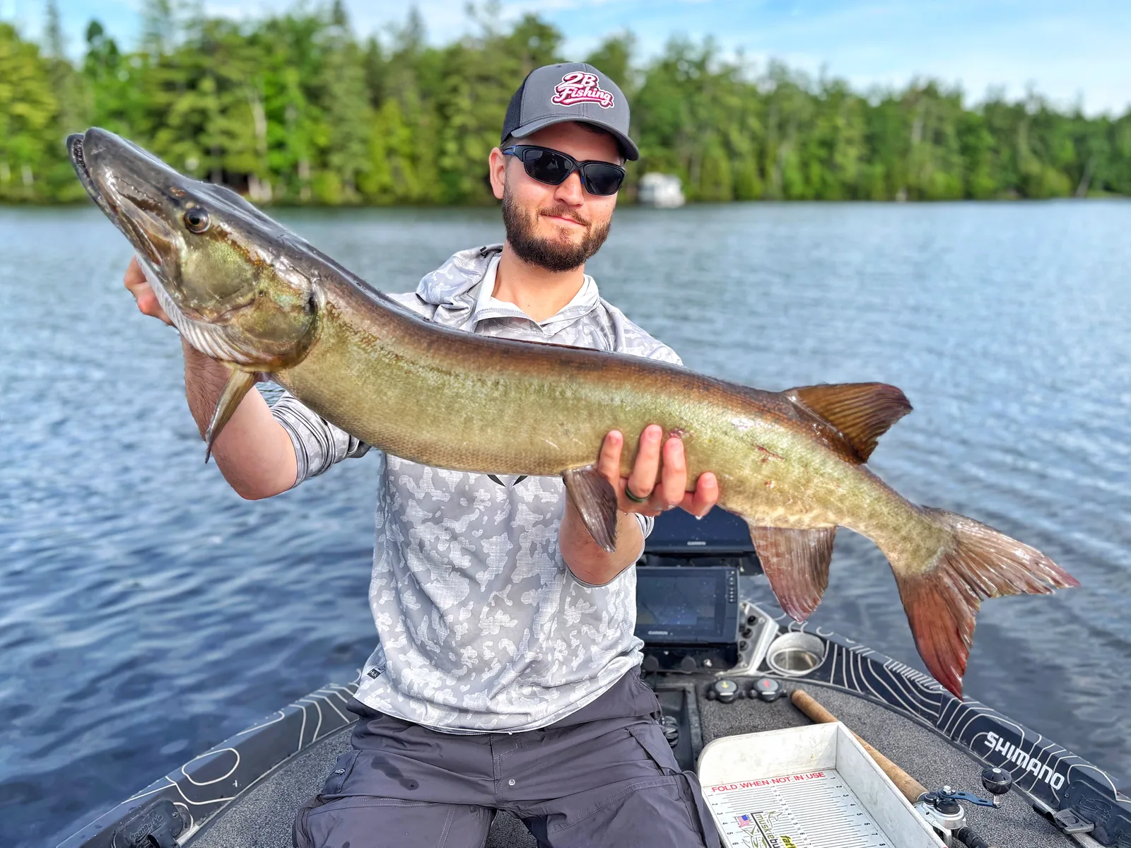 Jesse from Fishing Loons holding a muskie while fishing.