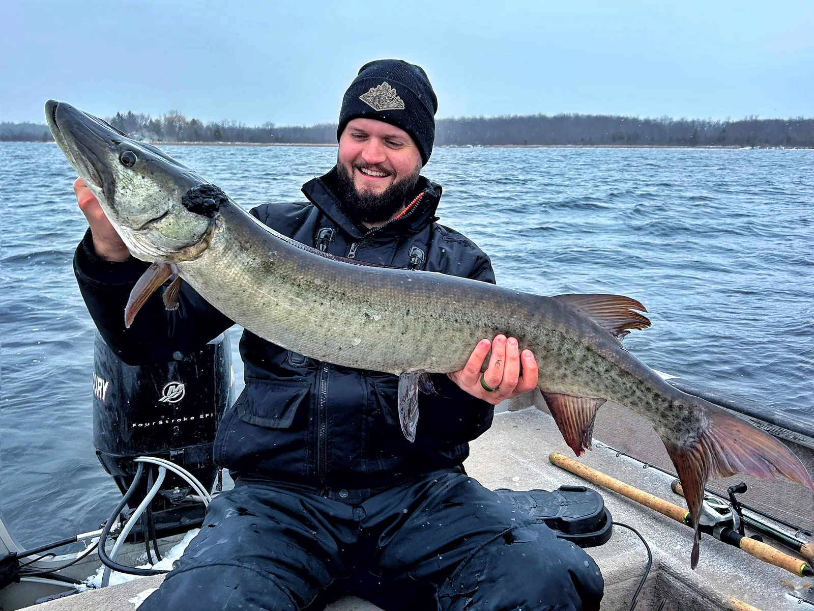 Jesse from Fishing Loons holding a muskie while fishing.