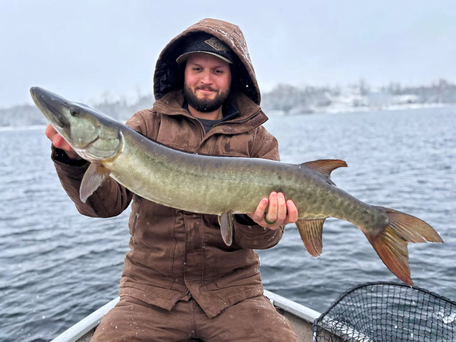 Jesse from Fishing Loons holding a muskie while fishing.