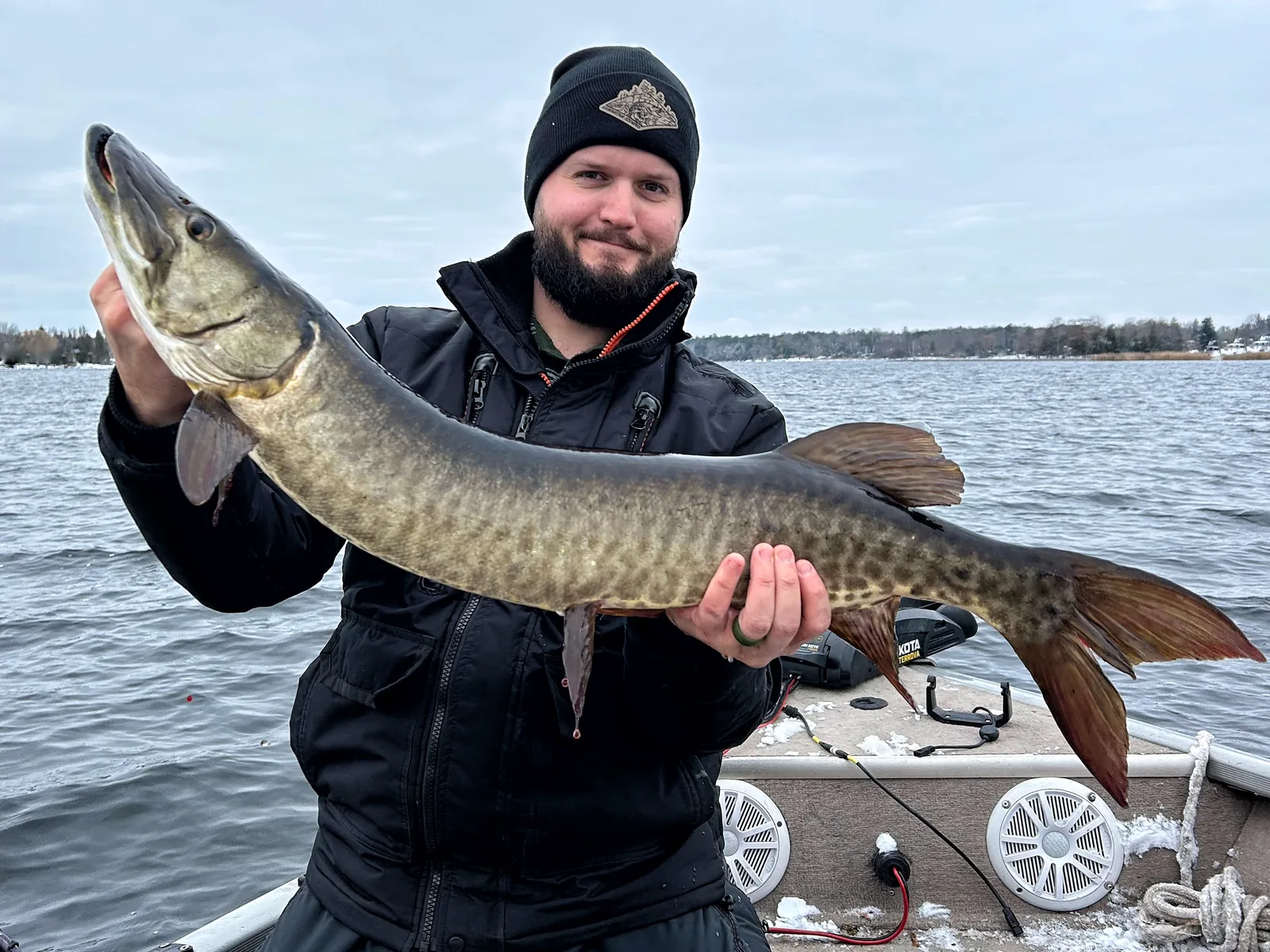 Jesse from Fishing Loons holding a muskie while fishing.