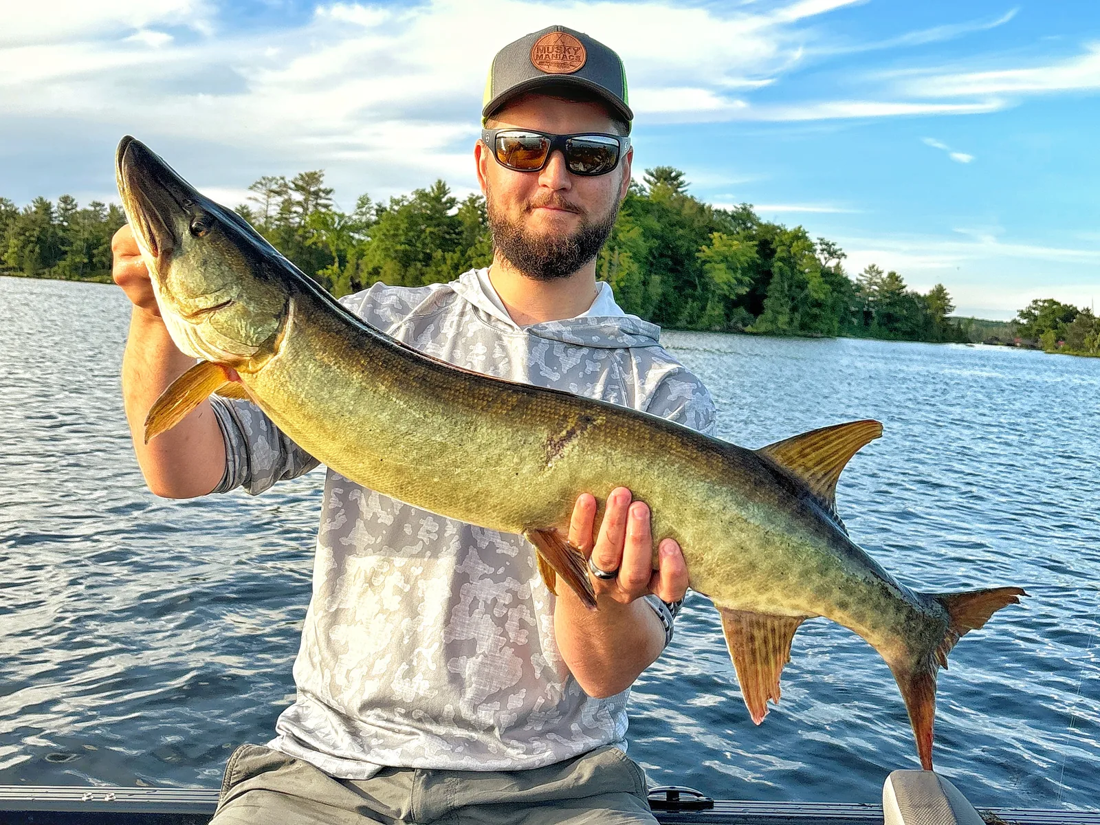 Jesse from Fishing Loons holding a muskie while fishing.