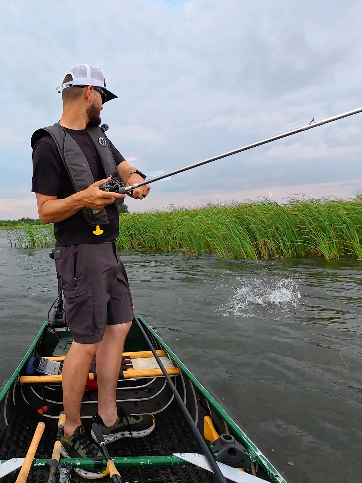 Jesse from Fishing Loons fishing from a boat on the water.