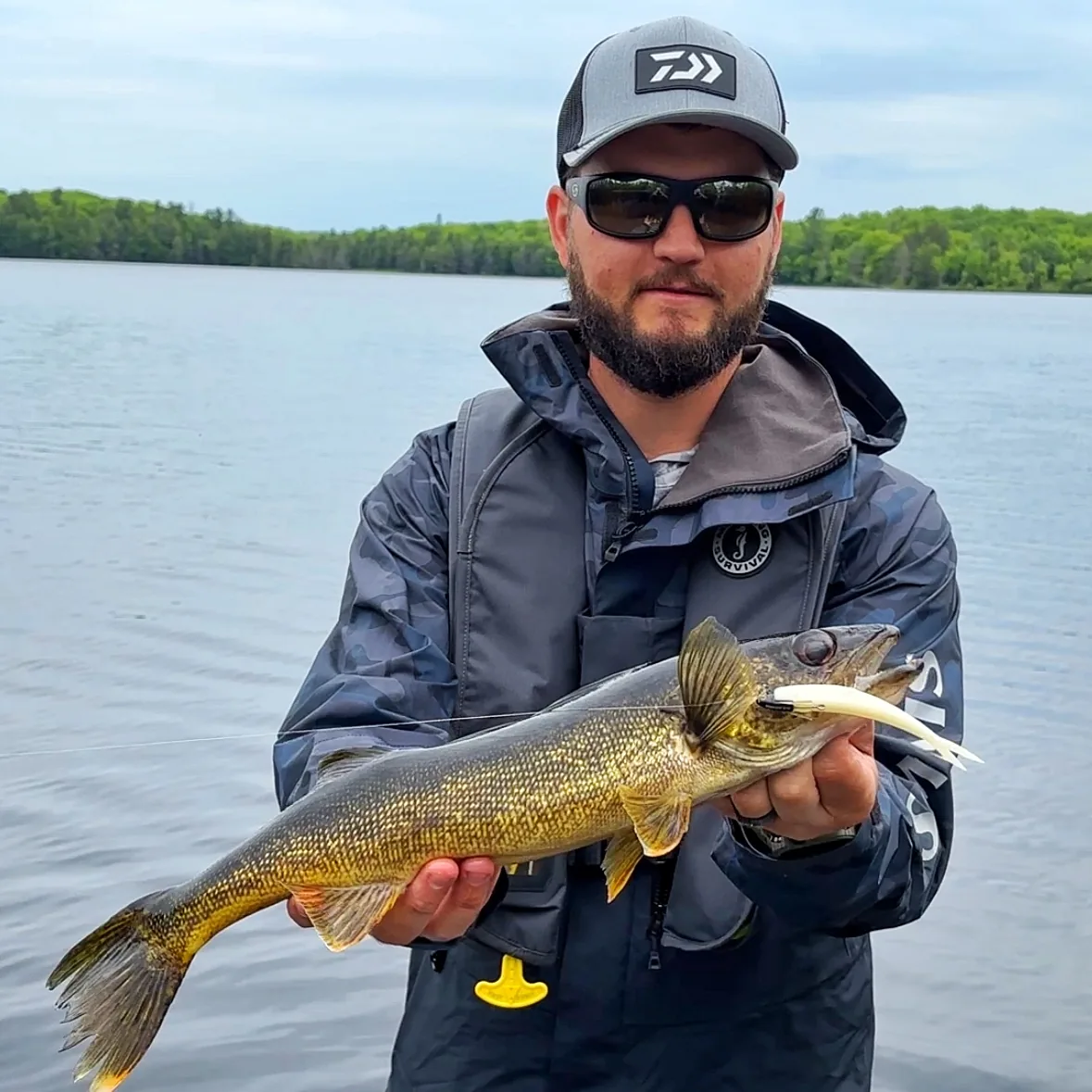 Jesse from Fishing Loons holding a walleye while fishing.