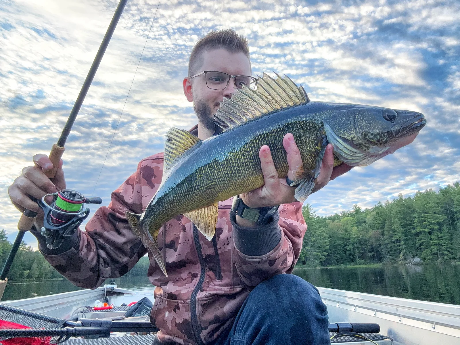 Jesse from Fishing Loons holding a walleye while fishing.